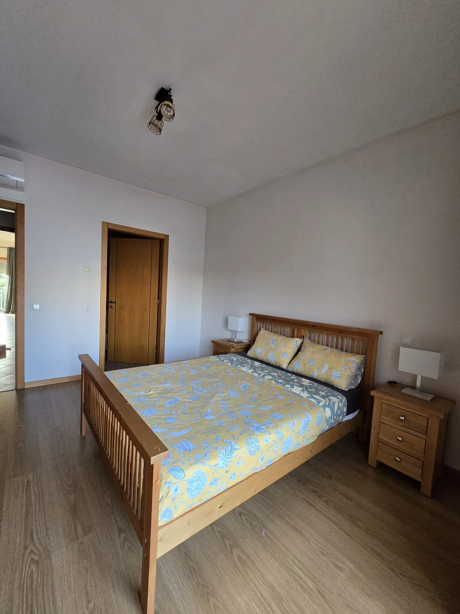 Main bedroom with double bed and wooden floors